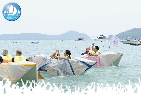 cardboard boat building event with craft on the start line on the clear waters of ao yon bay, phuket