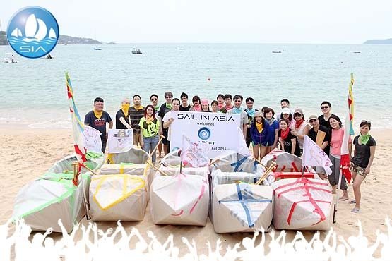 a corporate team from microsoft holding their teambuilding sail in asia banner at the end of a succesful event photograph