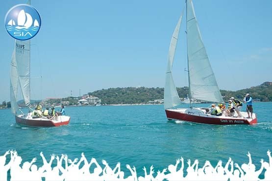 a corporate team sailing teambuilding race with two yachts in the azure blue sea of ao yon phuket