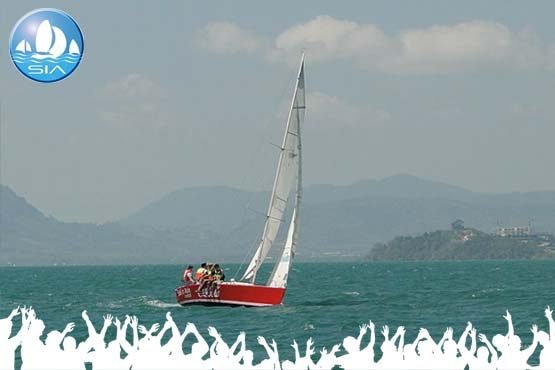 corporate team sailing event on a small red yacht in the tropical andaman sea, Phuket