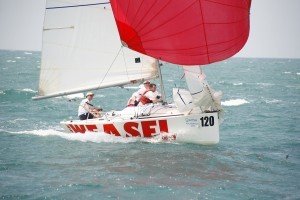 sail in asia's platu dinghy being crewed by an executive team during a corporate sailing regatta